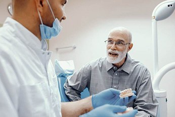 man at a consultation for dentures in Allen, TX