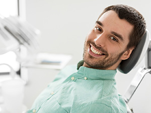 Male dental patient smiling before dental sedation in Allen, TX