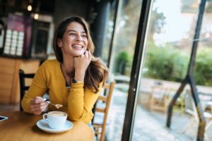 smiling woman drinking coffee