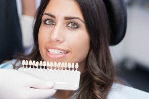 woman getting veneers from her cosmetic dentist in Allen 